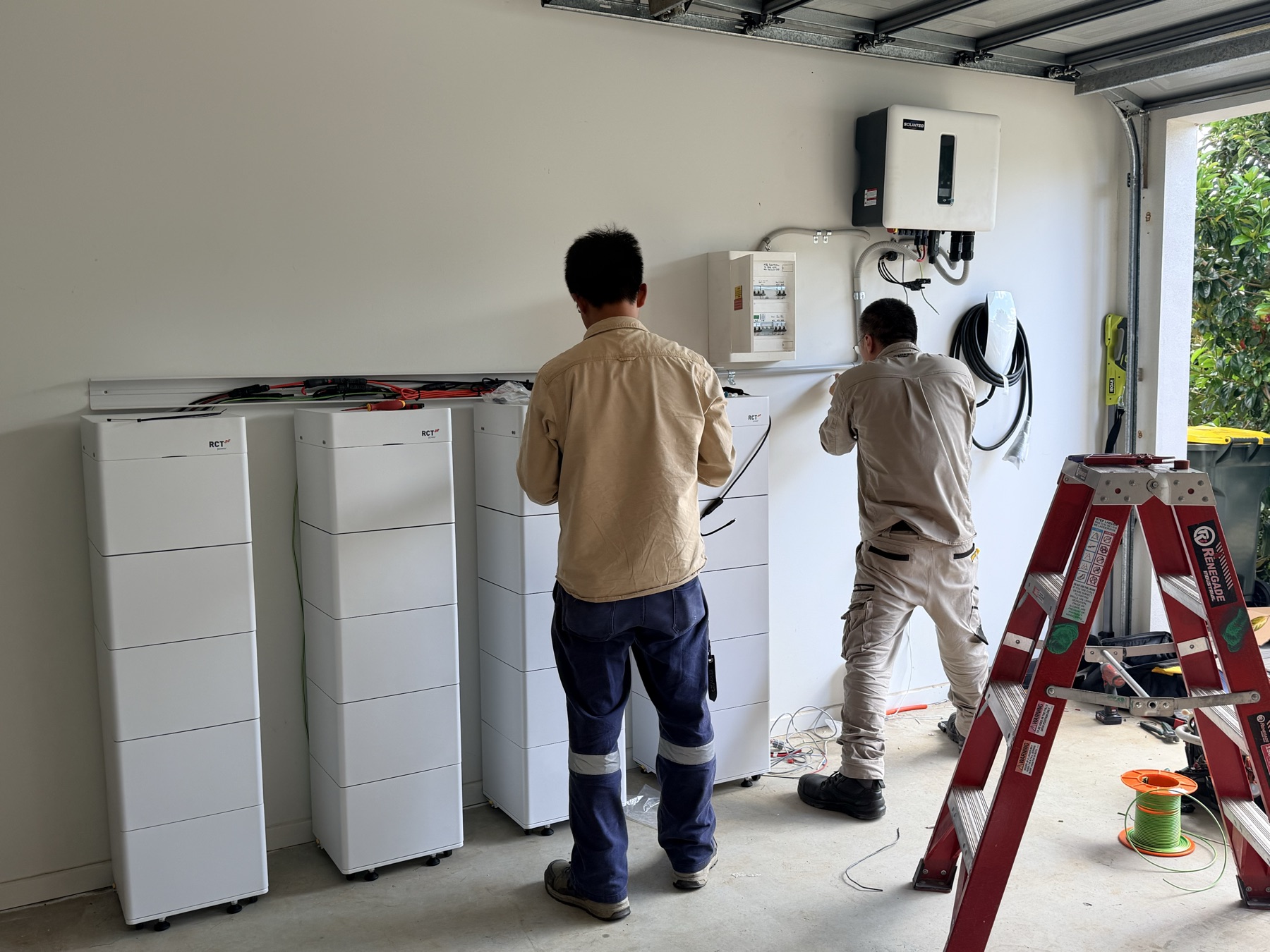 Megawatt electricians wiring the battery towers and inverter